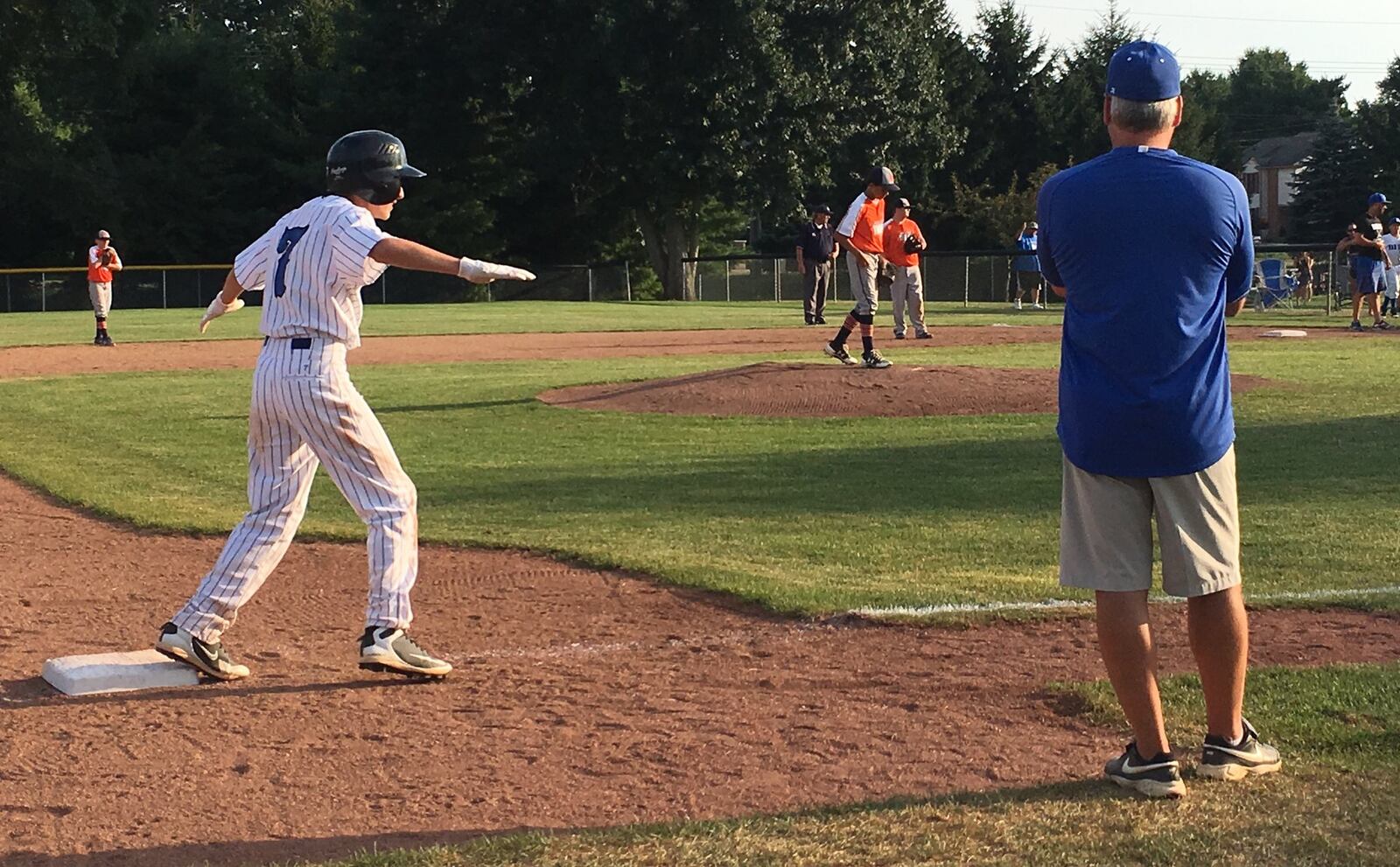 Hamilton West Side’s Noah Prewitt is eager to score from third base as coach Tim Nichting looks on Thursday night during a 15-1 win over Galion in the Ohio Little League Tournament at the Hoover Community Recreation Complex in North Canton. RICK CASSANO/STAFF