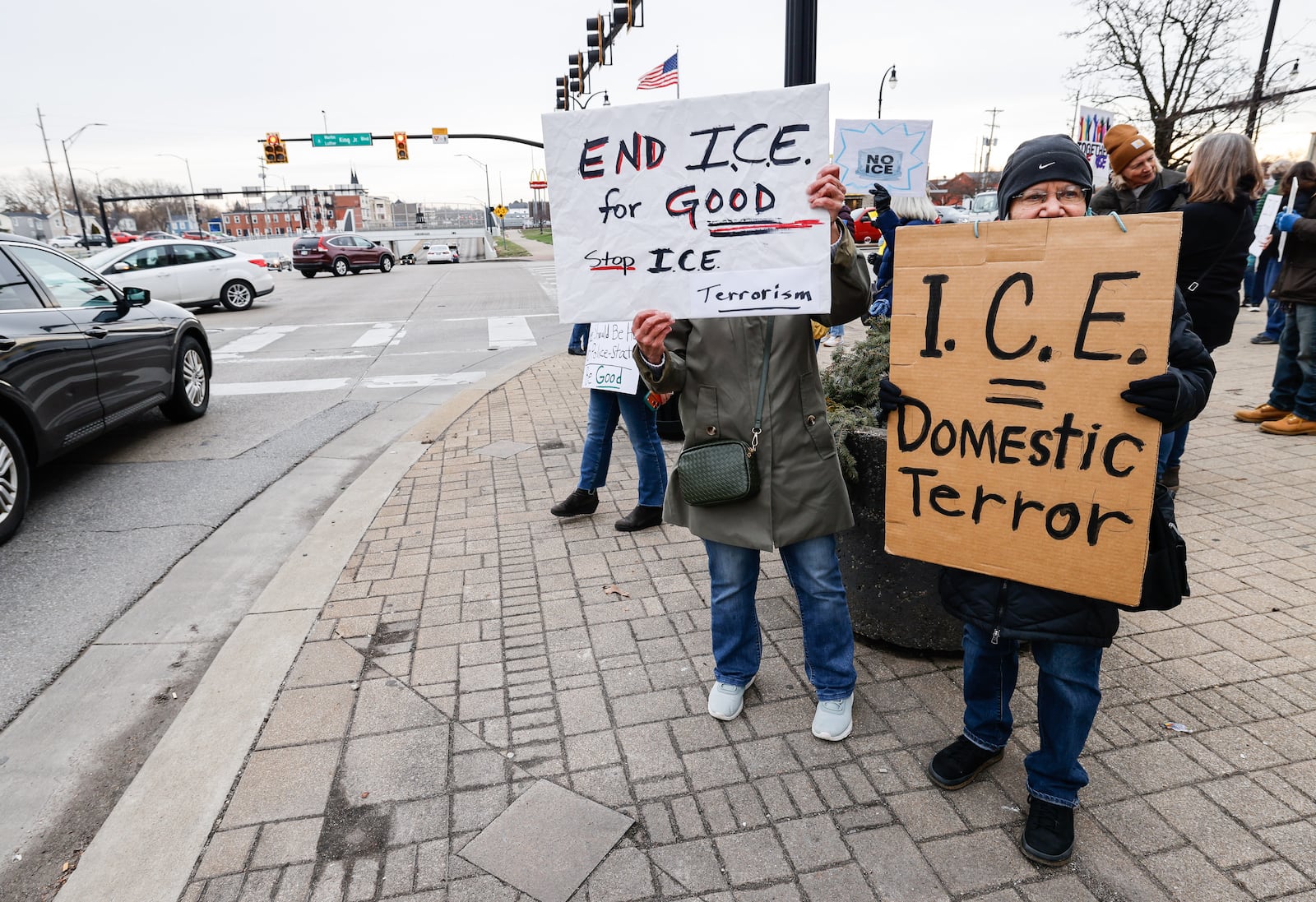 A group with Butler County for Immigrant Justice attended the Butler County Commission meeting to express their concerns over U.S. Immigration and Customs Enforcement detainees being housed in the Butler County jail and ask commissioners to end the contract. The group gathered at the corner of High Street and Martin Luther King Jr. Blvd. with signs after the meeting. NICK GRAHAM/STAFF