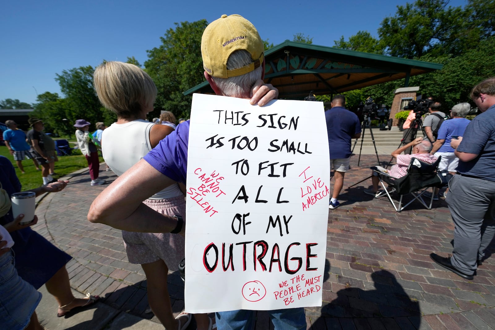 A local resident listen to a speech during an Iowa Democratic Party rally, Thursday, July 3, 2025, in Windsor Heights, Iowa. (AP Photo/Charlie Neibergall)