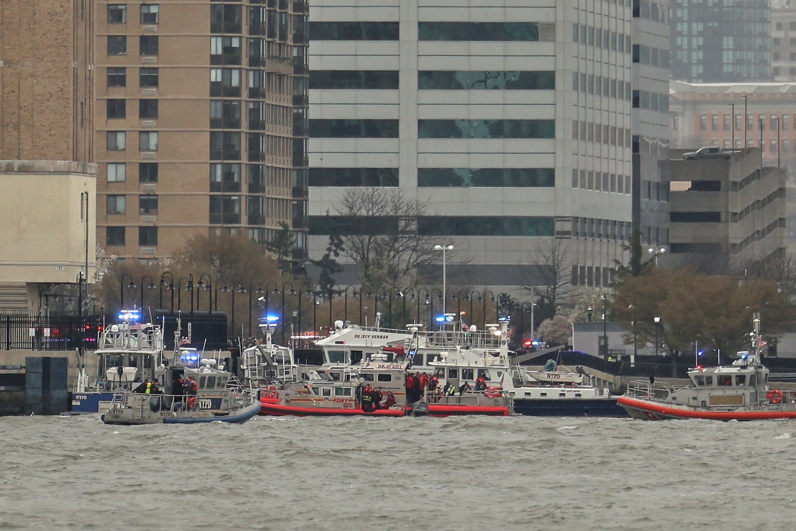 As seen from Pier 40 in New York, police and and fire crews from New York and New Jersey respond to the scene where a helicopter crashed into the Hudson River, Thursday, April 10, 2025, in Jersey City, N.J. (AP Photo/Yuki Iwamura)