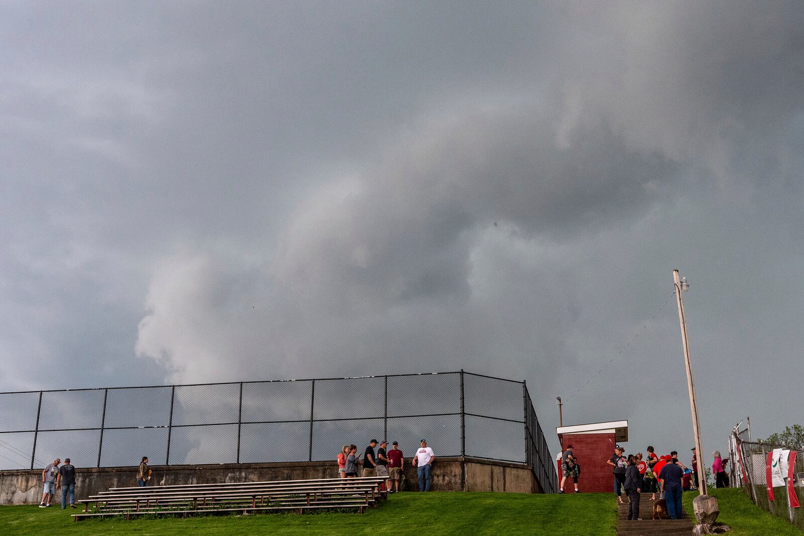 Fans head up the hill to the parking lots when the game was stopped between California and Fort Cherry High School baseball teams at Fort Cherry High School in McDonald, Pa., Tuesday, April 29, 2025. (Lucy Schaly/Pittsburgh Post-Gazette via AP)