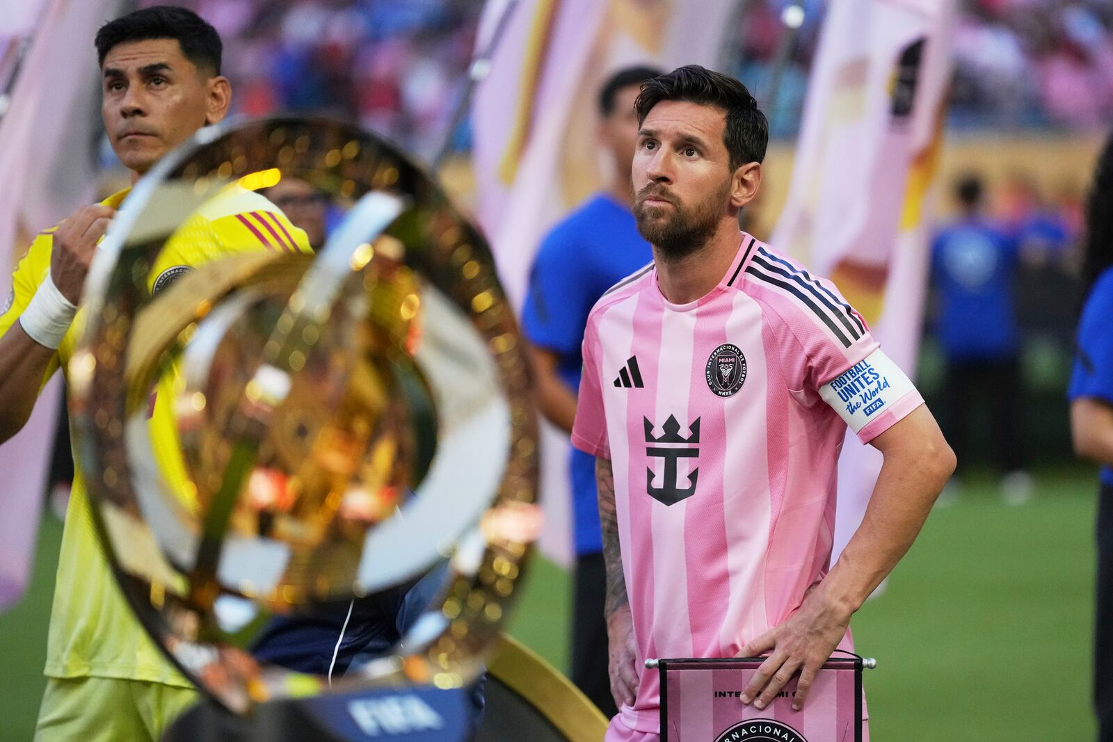 Inter Miami's Lionel Messi, right, and goalkeeper Oscar Ustari stand next to the trophy prior to the Club World Cup group A soccer match between Al Ahly and Inter Miami in Miami, Fla., Saturday, June 14, 2025. (AP Photo/Rebecca Blackwell)