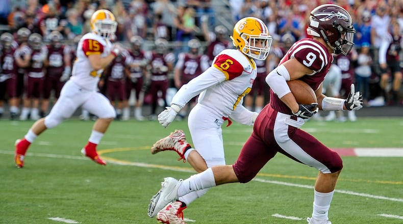 Lebanon’s Derrick Allen is trailed by Fenwick’s Dawson Demers (6) and Henry Nenni (15) as he returns the opening kickoff for a touchdown Sept. 8, 2017, at Jim VanDeGrift Stadium in Lebanon. The host Warriors won 49-27. NICK GRAHAM/STAFF