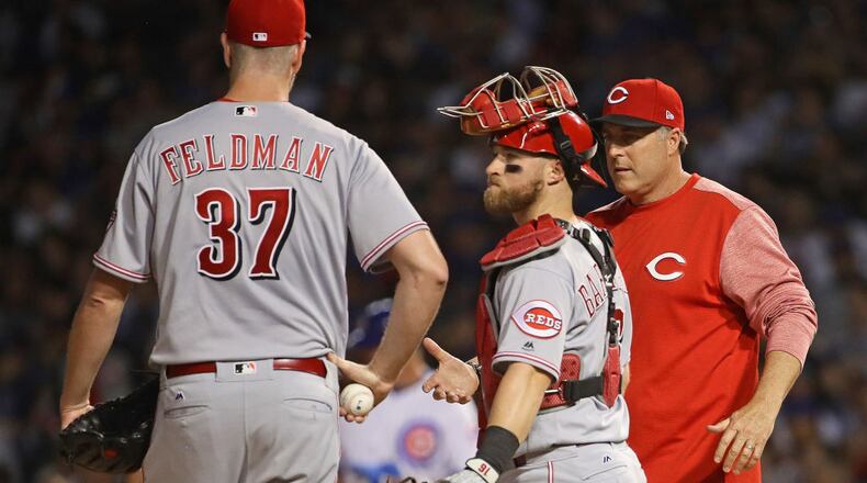 CHICAGO, IL - MAY 17:   Manager  Bryan Price #38 of the Cincinnati Reds takes starting pitcher Scott Feldman our of the game in the 3rd inning against the Chicago Cubs as Tucker Barnhart #16 watches at Wrigley Field on May 17, 2017 in Chicago, Illinois. (Photo by Jonathan Daniel/Getty Images)