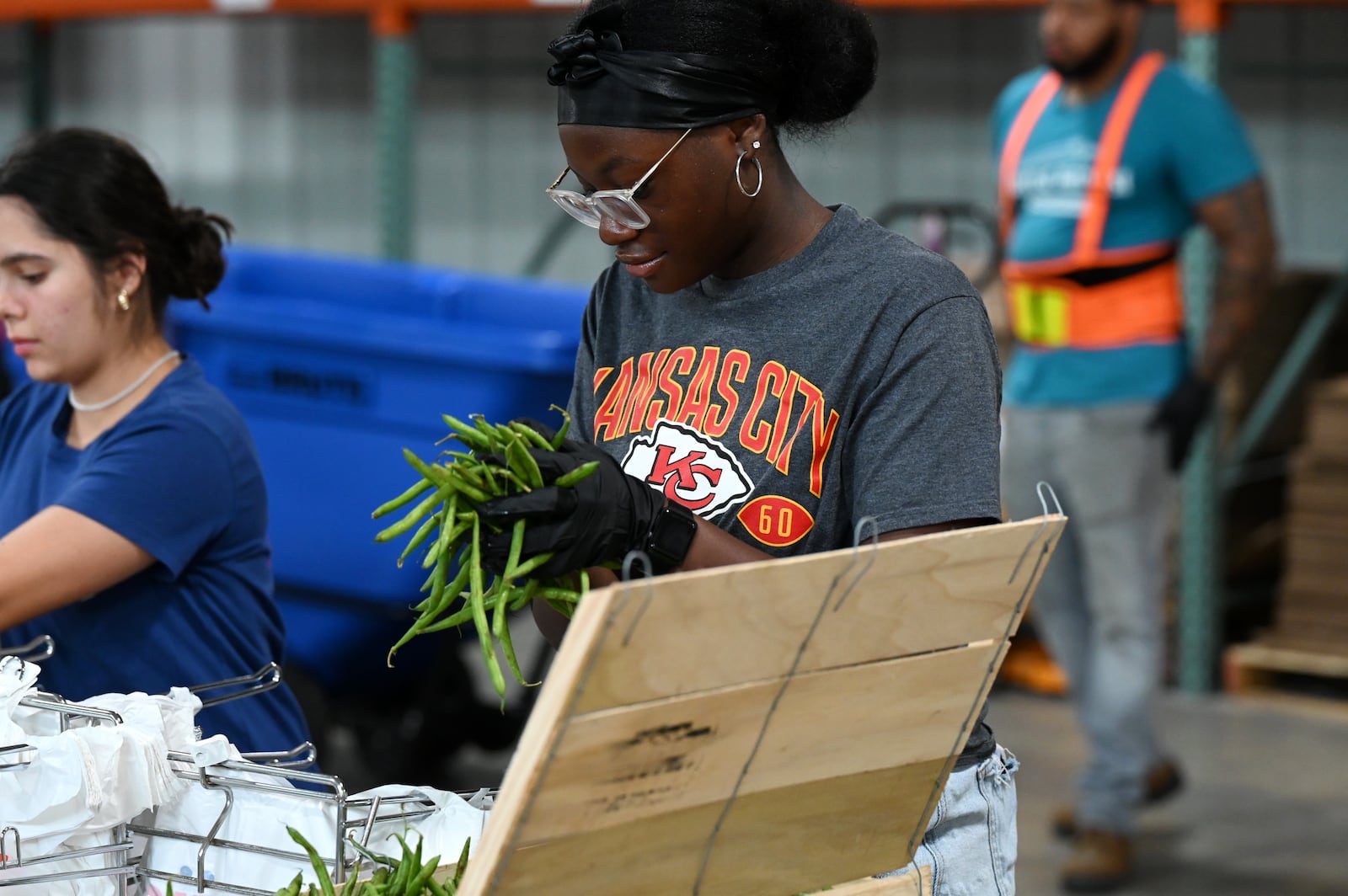 Pictured are volunteers at Shared Harvest Foodbank in Fairfield, Ohio, on Wednesday, July 9, 2025, packaging food in preparation for distribution. The federal cut to Supplemental Nutrition Assistance Program, or SNAP, benefits with the passage of the so-called "One Big Beautiful Bill" approved by Congress and signed by President Donald Trump, organizations like Shared Harvest expect to see an increase in clients as federal food supplies decrease. "Our greatest concern is that we continue in the pattern of reducing food sources, and we continue to see growing numbers of people coming to our network,” said Shared Harvest Executive Director Terry Perdue. “It’s less food and more people needing access to charitable food.” MICHAEL D. PITMAN/STAFF