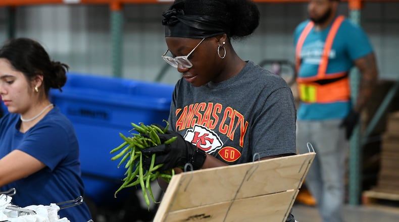 Volunteers at Shared Harvest Foodbank in Fairfield on Wednesday, July 9, 2025, package food in preparation for distribution. Nearly 40,000 people will not have access to SNAP benefits after Friday. STAFF
