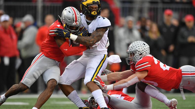 COLUMBUS, OH - NOVEMBER 24: Jeffrey Okudah #1 of the Ohio State Buckeyes hits Tarik Black #7 of the Michigan Wolverines in the first quarter after a gain at Ohio Stadium on November 24, 2018 in Columbus, Ohio. (Photo by Jamie Sabau/Getty Images)