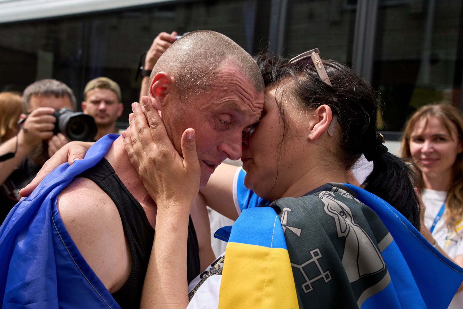 Ukrainian serviceman Vitaly kisses his wife, Olena, after returning from captivity during a POWs exchange between Russia and Ukraine, in Chernyhiv region, Ukraine, Sunday, May 25, 2025. (AP Photo/Efrem Lukatsky)