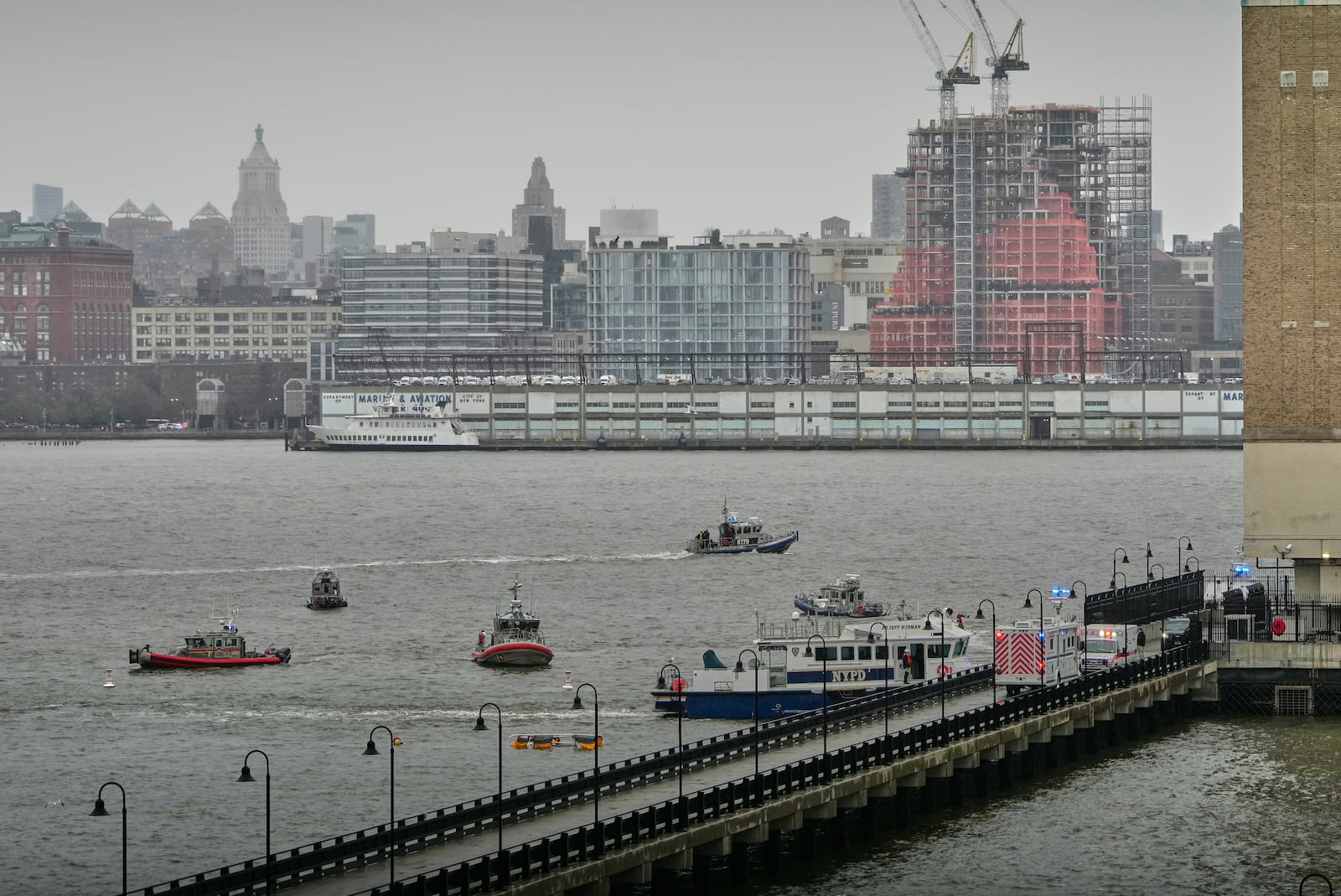 First responders from New Jersey and New York respond to the scene where a helicopter crashed in the Hudson River, Thursday, April 10, 2025, in Jersey City, N.J. (AP Photo/Seth Wenig)