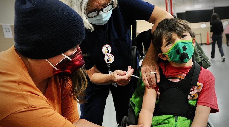 Ezio Hoos, age 5, makes a face while getting his COVID-19 vaccination in Springfield on Thursday Nov. 4, 2021. MARSHALL GORBY\STAFF