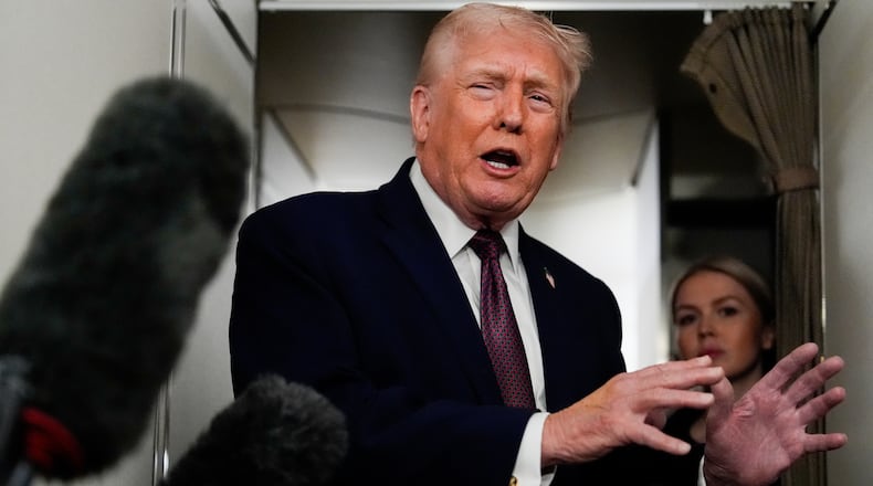 President Donald Trump speaks to reporters while in flight on Air Force One to Joint Base Andrews, Md., Sunday, Jan. 11, 2026. (AP Photo/Julia Demaree Nikhinson)