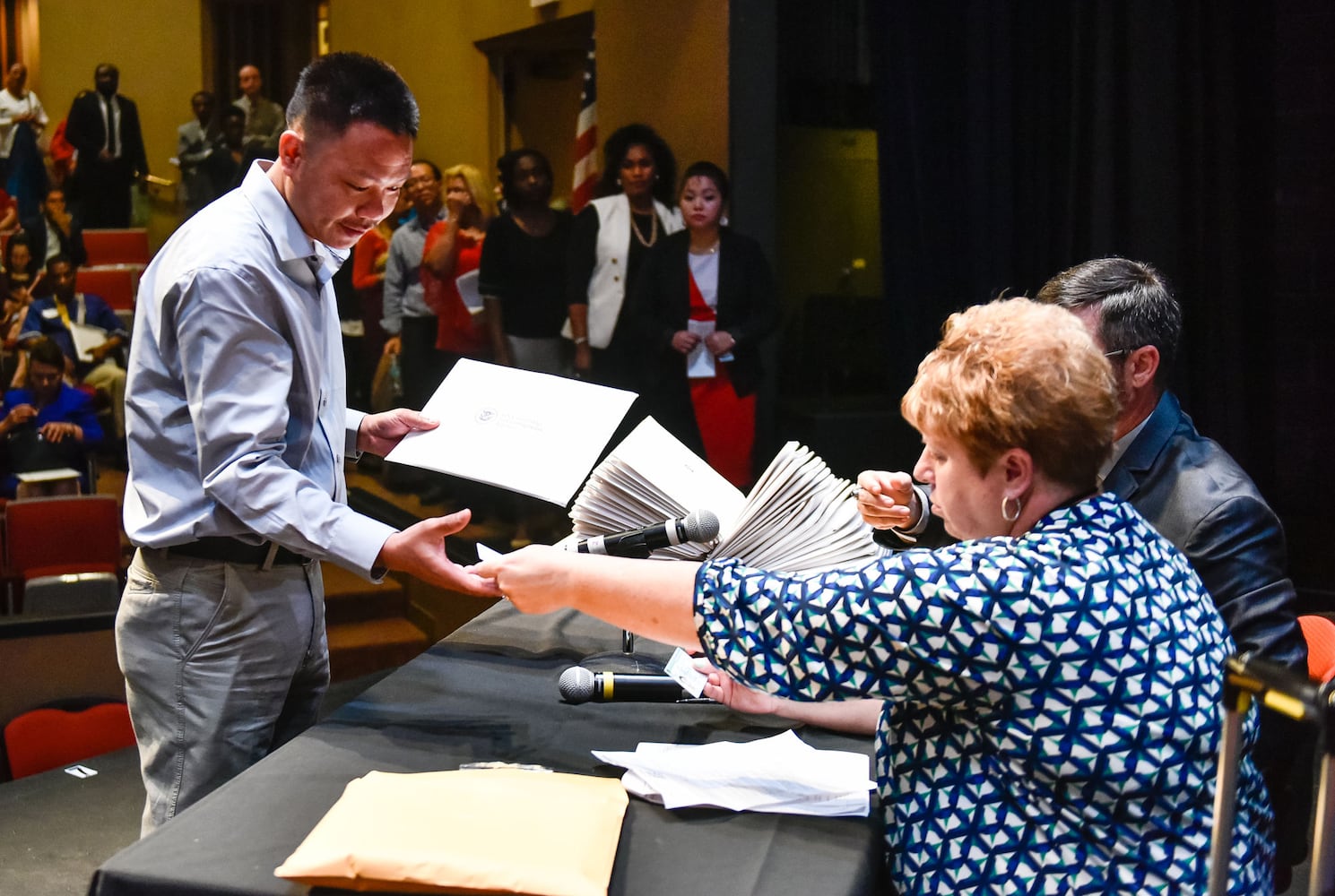 Nearly 100 people become U.S. citizens at naturalization ceremony at Miami Hamilton