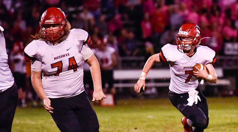 Madison quarterback Mason Whiteman carries the football as Caleb Bolen looks to block for him during their Oct. 6 game at Carlisle. The visiting Mohawks won 31-14. NICK GRAHAM/STAFF