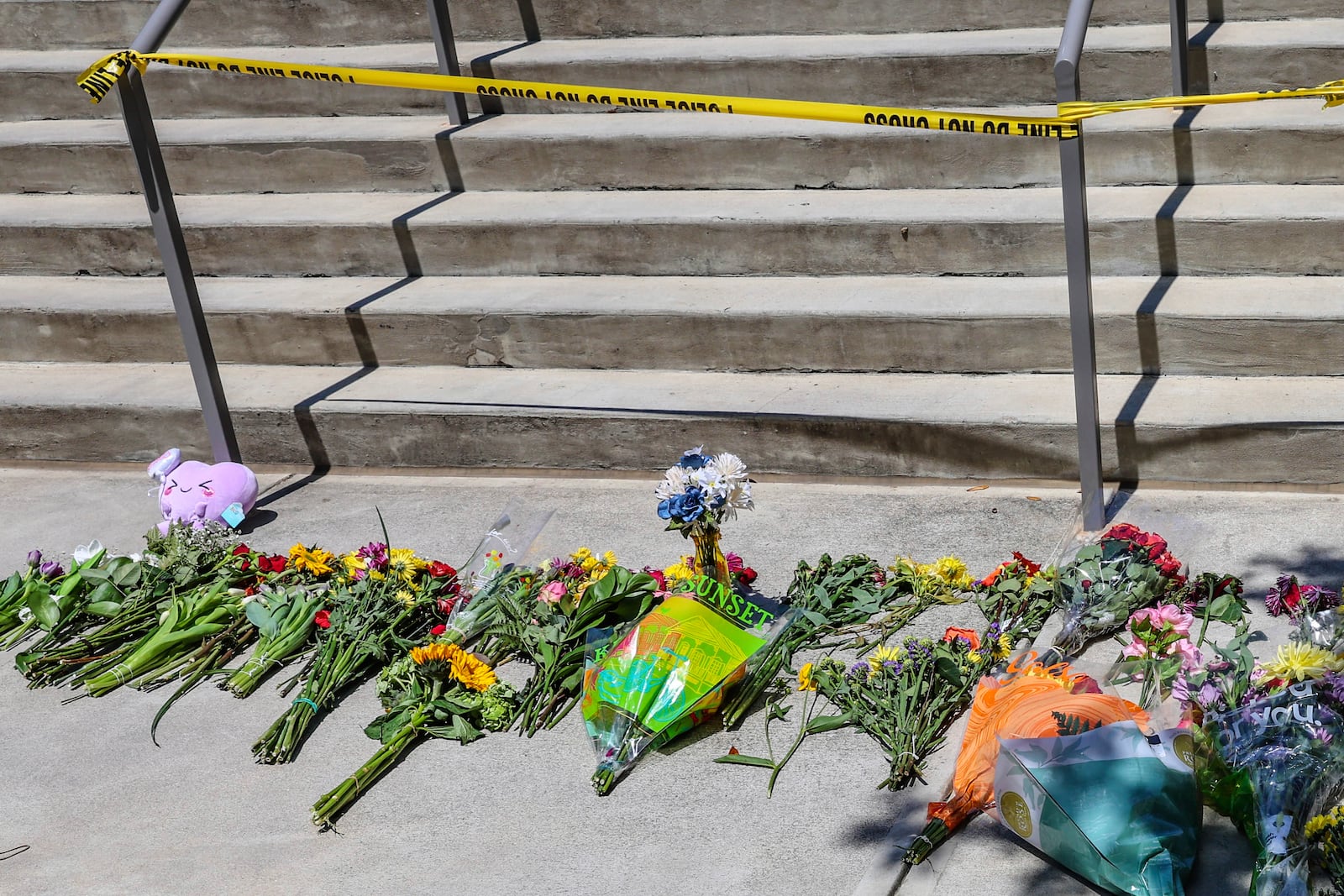 Flowers placed by students sit near police tape near the Florida State Student Union building, Tallahassee, Fla., Friday, April 18, 2025. (AP Photo/Gary McCullough)