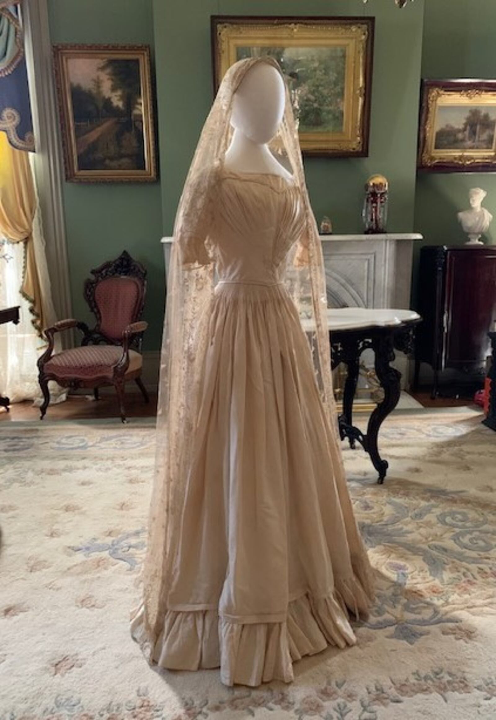 Pictured is a wedding dress worn by Mary Woods Falconer in 1839 as seen in the parlor of the Benninghofen House. The veil for the dress was worn by seven of her descendants through 1990. CONTRIBUTED