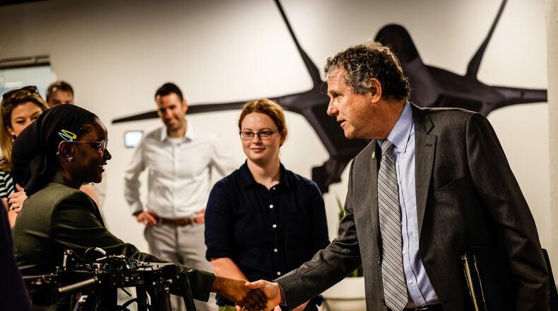 Ohio Senator Sherrod Brown shakes the hand of Wright Brothers Institute intern, Nene Bah at the institute Tuesday June 29, 2021. Brown was touring the facility. JIM NOELKER/STAFF