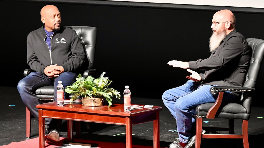 Pinball Garage owner Brad Baker asks entrepreneur Daymond John, who is one of the investors on the television show Shark Tank, Thursday evening, Nov. 14, 2025, on the Parrish Auditorium stage at Miami University Hamilton. The interview and discussion was part of the Harry T. Wilks Distinguished Lecture Series. John, known as "The People's Shark," invested in Baker's VPcabs Virtual Pinball business in 2016, which he has since sold. MICHAEL D. PITMAN/STAFF