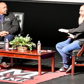 Pinball Garage owner Brad Baker asks entrepreneur Daymond John, who is one of the investors on the television show Shark Tank, Thursday evening, Nov. 14, 2025, on the Parrish Auditorium stage at Miami University Hamilton. The interview and discussion was part of the Harry T. Wilks Distinguished Lecture Series. John, known as "The People's Shark," invested in Baker's VPcabs Virtual Pinball business in 2016, which he has since sold. MICHAEL D. PITMAN/STAFF