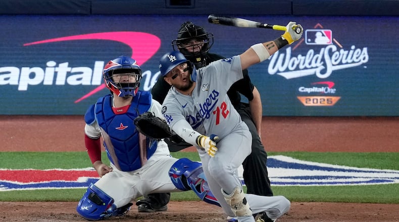 Los Angeles Dodgers' Miguel Rojas follows through on a home run against the Toronto Blue Jays during the ninth inning in Game 7 of baseball's World Series, Saturday, Nov. 1, 2025, in Toronto. (AP Photo/Ashley Landis)