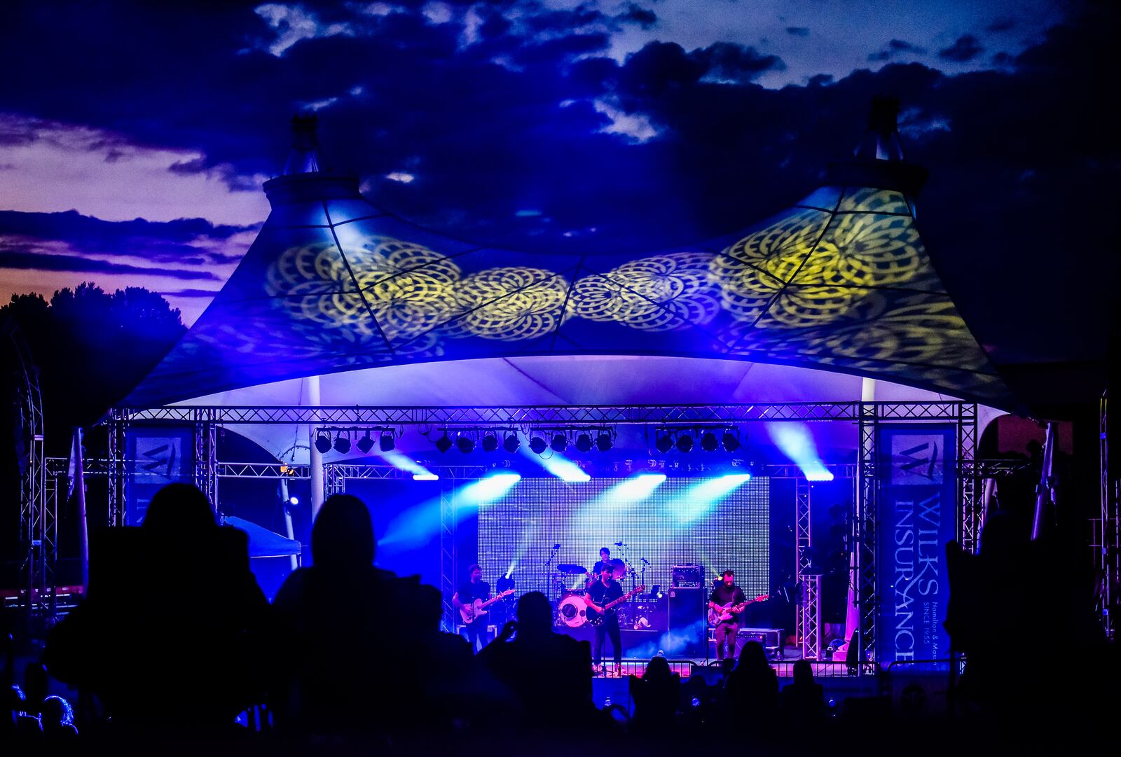 Flying Buffaloes and Motherfolk performed at RiversEdge Amphitheater Thursday, August 6, 2020 with limited capacity to meet social distancing requirements. The RiversEdge concerts series is normally free but they have fenced off the area and attendees must now purchase tickets to reserve a square marked out on the grass designated as their seating area. The squares are spaced out around the venue with plenty of room to walk between them and stay distanced. NICK GRAHAM / STAFF