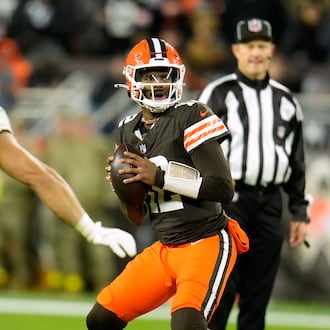 Cleveland Browns quarterback Shedeur Sanders (12) prepares to throw a pass under pressure from Baltimore Ravens linebacker Teddye Buchanan (40) in the second half of an NFL football game in Cleveland, Sunday, Nov. 16, 2025. (AP Photo/Sue Ogrocki)