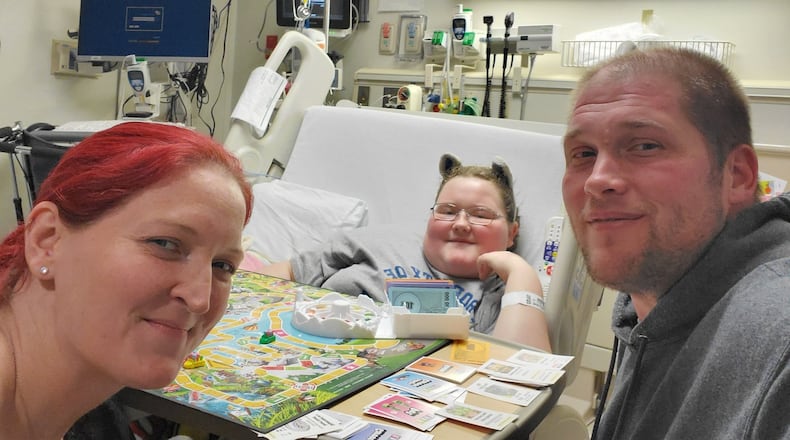 This picture with her parents was taken before Saige Ryan lost her hair and her parents, Opal and Sam Ryan shaved their heads. SUBMITTED PHOTO
