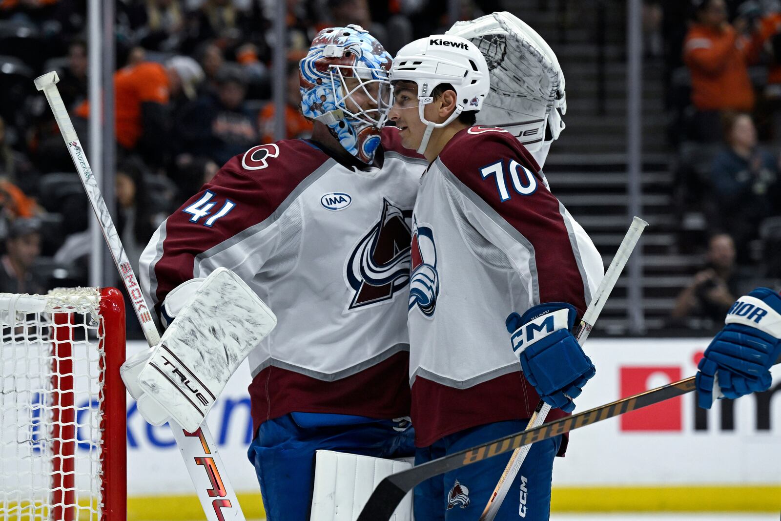 Colorado Avalanche defenseman Sam Malinski (70) celebrates with goaltender Scott Wedgewood (41) after the Avalanche defeated the Anaheim Ducks in an NHL hockey game in Anaheim, Calif., Sunday, April 13, 2025. (AP Photo/Alex Gallardo)