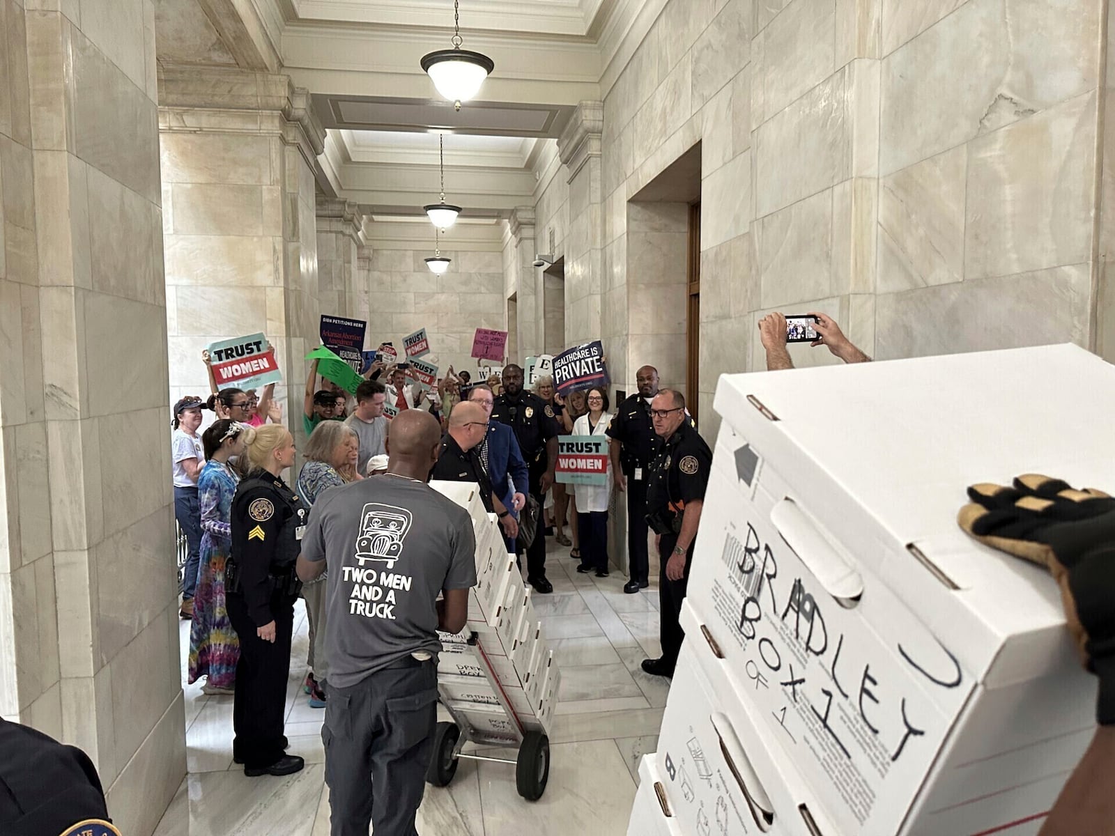 FILE - Boxes containing signatures supporting a proposed ballot measure to scale back Arkansas' abortion ban are delivered to a room in the state Capitol on July 5, 2024, in Little Rock, Ark. (AP Photo/Andrew DeMillo, File)