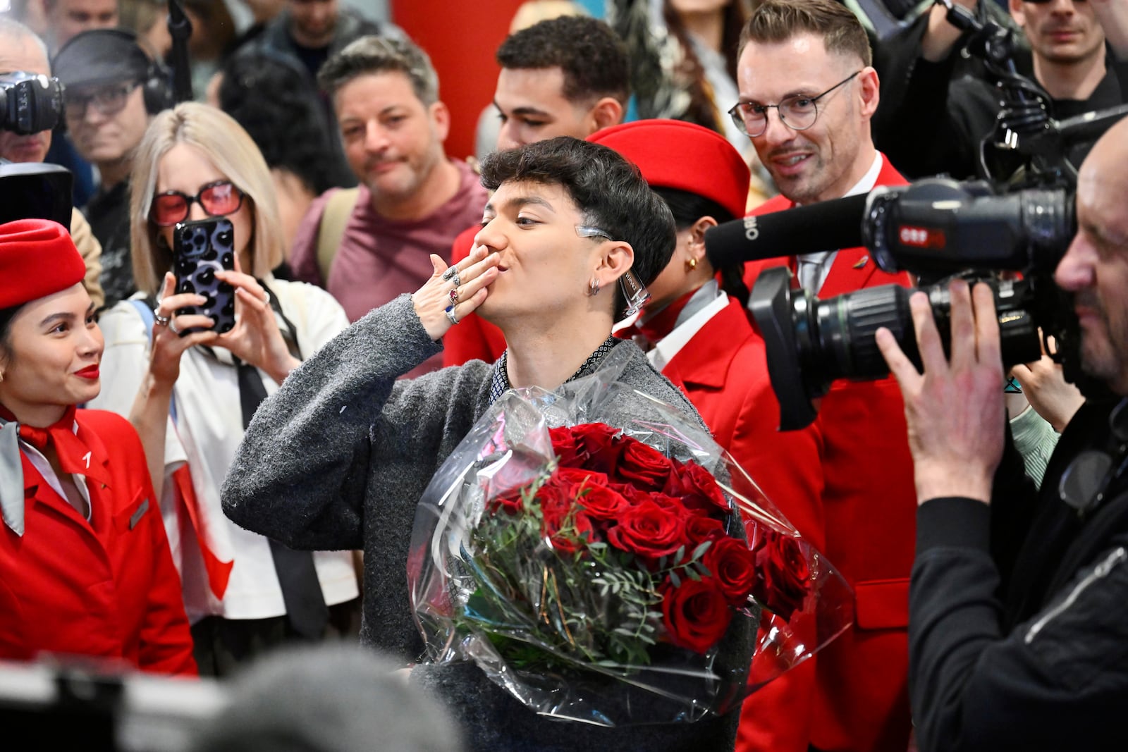 JJ, center, from Austria arrives at the airport in Vienna, Austria, Sunday, May 18, 2025, after winning the Grand Final of the 69th Eurovision Song Contest, in Basel yesterday. (AP Photo/Denes Erdos)