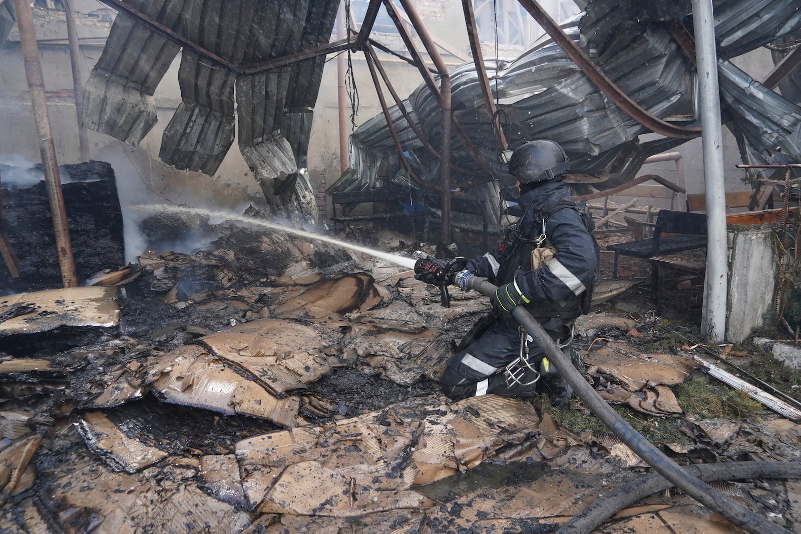 Firefighters tackle the blaze after a Russian attack that hit a residential area in Kharkiv, Ukraine, Thursday, July 24, 2025. (AP Photo/Andrii Marienko)