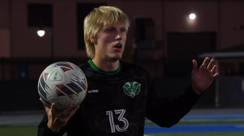 Badin junior Max Snellgrove (13) attempts a throw-in against McNicholas on Tuesday night. Chris Vogt/CONTRIBUTED