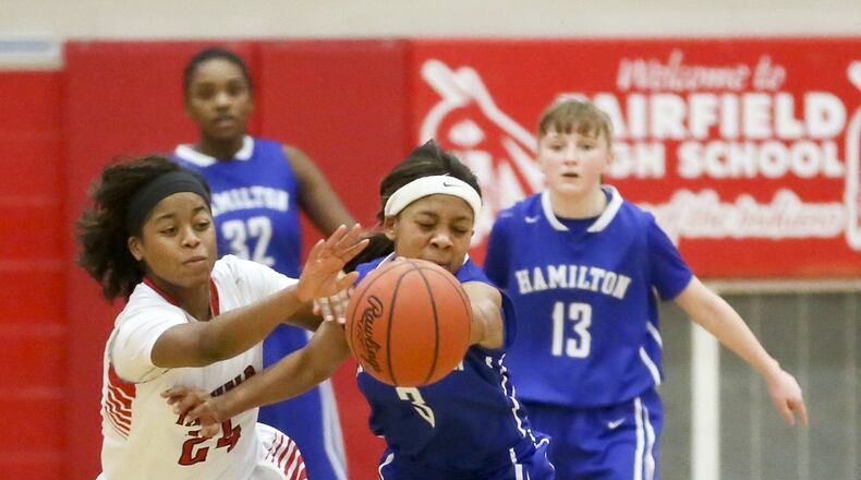 Fairfield guard Brooke Spaulding (24) and Hamilton guard Takyra Gilbert (3) battle for a loose ball during their game at Fairfield Arena on Feb. 7, 2015. GREG LYNCH/STAFF