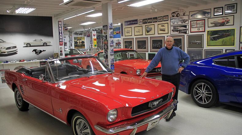 Gale Halderman poses with his Mustangs at the Halderman Barn Museum in Tipp City in 2017. Halderman is leaning on a 1965 Mustang convertible, the first Mustang he bought, in 2012. SKIP PETERSON/CONTRIBUTOR