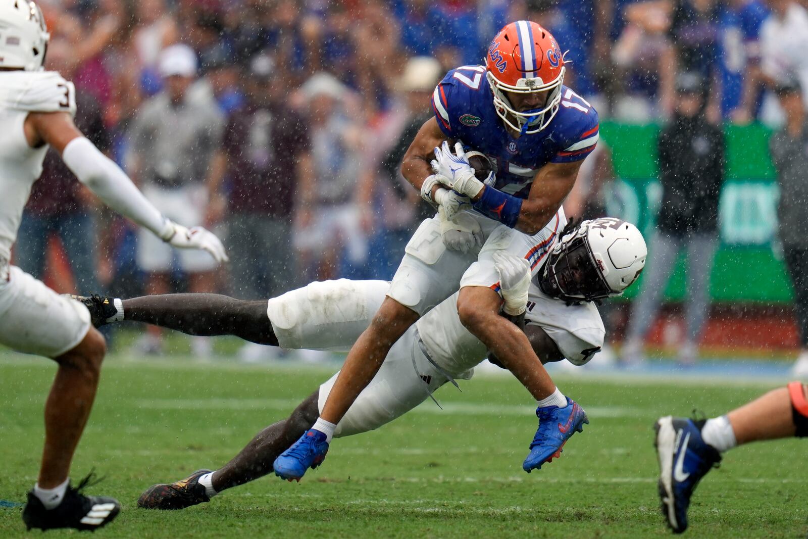 Florida wide receiver Chimere Dike (17) is stopped after a reception by Texas A&M defensive lineman Shemar Stewart during the first half of an NCAA college football game, Saturday, Sept. 14, 2024, in Gainesville, Fla. (AP Photo/John Raoux)