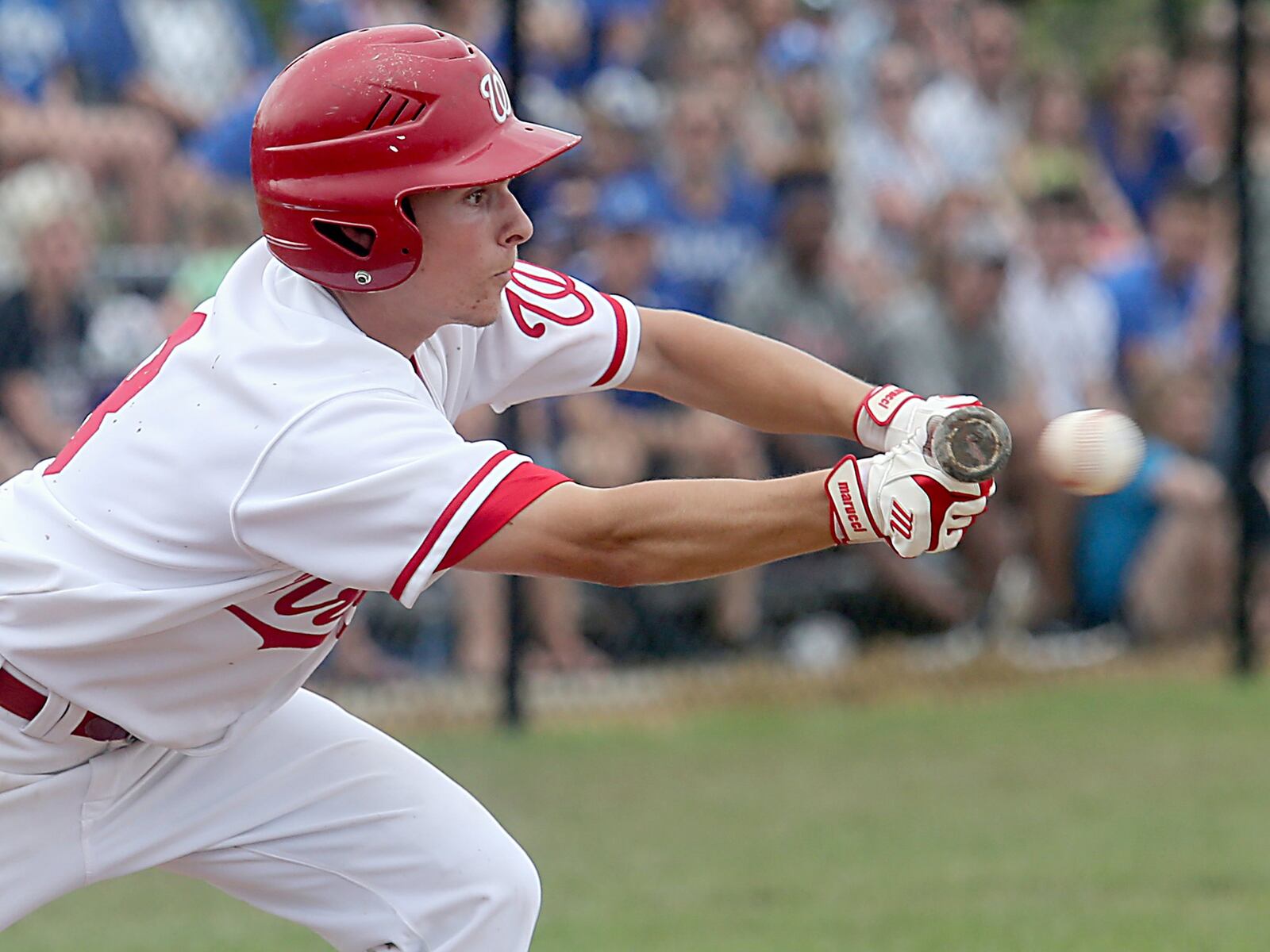 Lakota West’s A.J. Petersen attempts to get a bunt down against Springboro during Saturday’s Division I district final at Centerville. CONTRIBUTED PHOTO BY E.L. HUBBARD