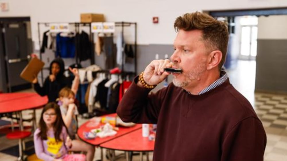 While most school principals employ acoustic options such as shouting, hand claps, whistles, hand bells and the occasional megaphone with big gatherings of students, Central Academy Principal Stephen Sippel just reaches into his pocket for his ever-present harmonica and hits a few notes. NICK GRAHAM/STAFF