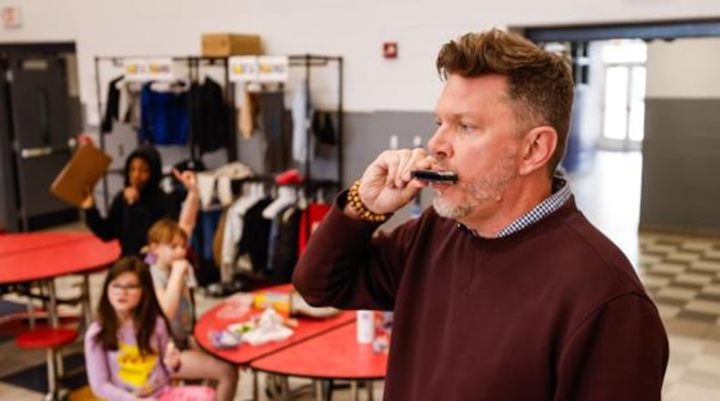 While most school principals employ acoustic options such as shouting, hand claps, whistles, hand bells and the occasional megaphone with big gatherings of students, Central Academy Principal Stephen Sippel just reaches into his pocket for his ever-present harmonica and hits a few notes. NICK GRAHAM/STAFF