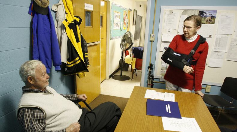 Pat and Roy Ickes, coordinators for the SHALOM homeless program, wait to check in visitors to the shelter eight years ago at First United Methodist Church in Middletown. Roy Ickes died in September, and SHALOM coordinators say they’re missing his leadership. NICK GRAHAM/2008