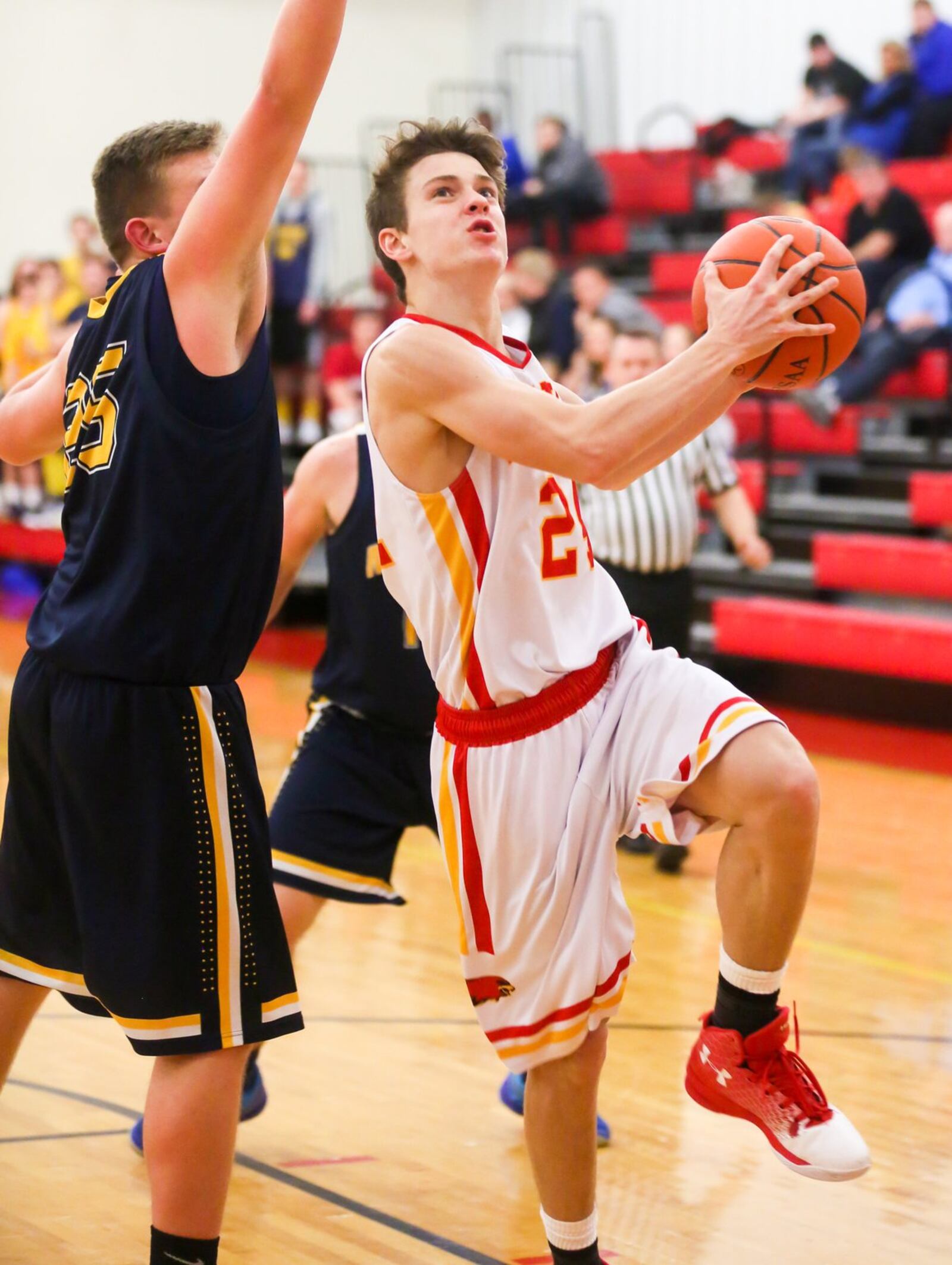 Fenwick guard David Luers (24) eyes the basket as Monroe’s Matt DeHart defends during Tuesday night’s game at Fenwick. GREG LYNCH/STAFF