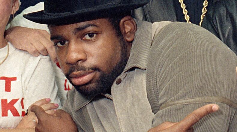 FILE -Run-D.M.C.'s Jason Mizell, Jam-Master Jay, poses with teenagers gathered at New York's Madison Square Garden, Oct. 7, 1986, in New York City. (AP Photo/G. Paul Burnett, File)