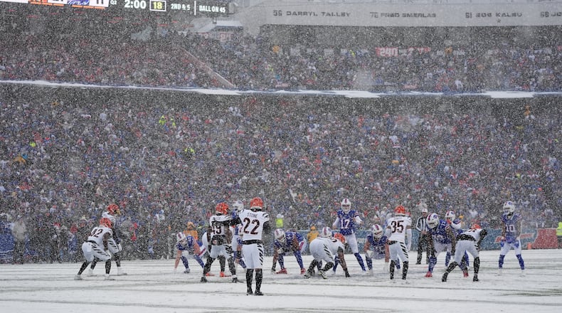 Snow falls as the Buffalo Bills line up for a play against the Cincinnati Bengals during the first half of an NFL football game, Sunday, Dec. 7, 2025, in Orchard Park, N.Y. (AP Photo/Gene J. Puskar)