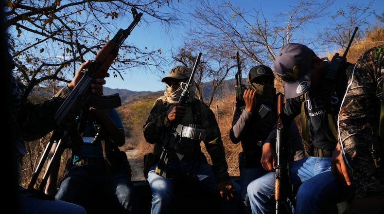Members of a local self-defense group formed by residents in response to cartel violence patrol in Guajes de Ayala, Mexico, Tuesday, March 10, 2026. (AP Photo/Marco Ugarte)