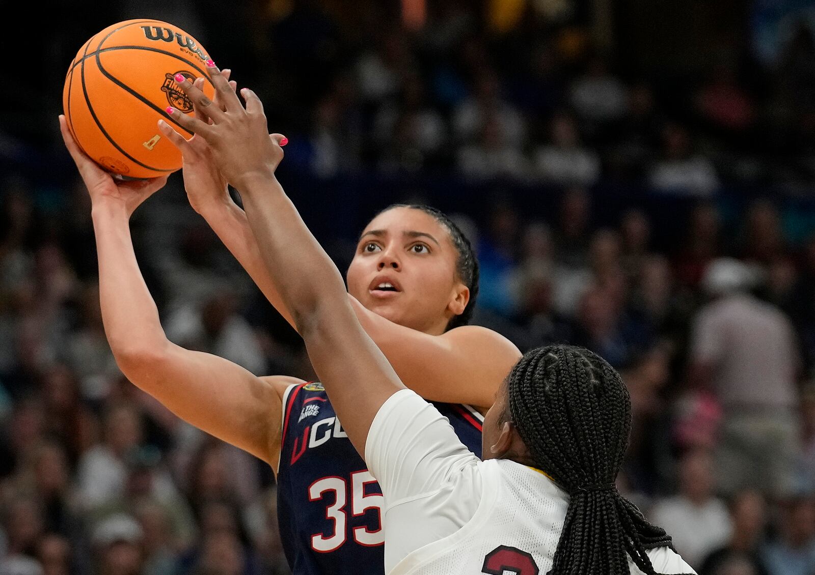 UConn guard Azzi Fudd (35) shoots against South Carolina forward Sania Feagin (20) during the first half of the national championship game at the Final Four of the women's NCAA college basketball tournament, Sunday, April 6, 2025, in Tampa, Fla. (AP Photo/Chris O'Meara)