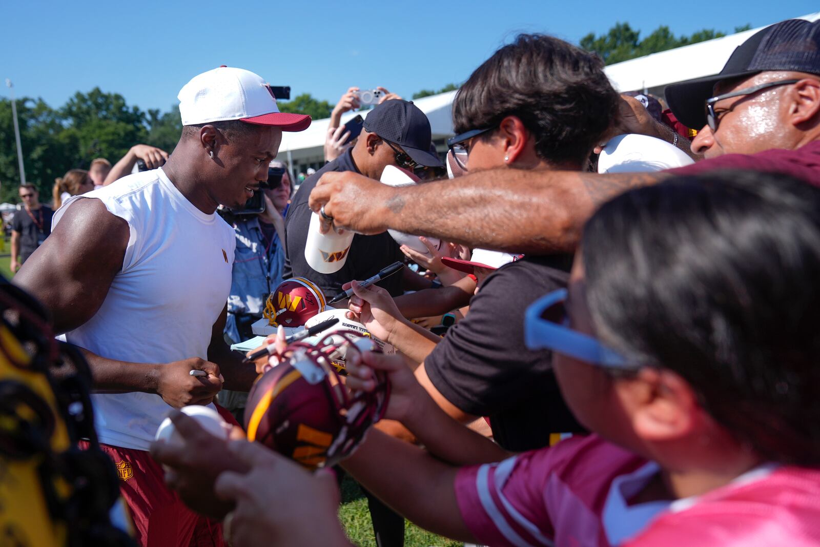 Washington Commanders wide receiver Terry McLaurin signs autographs for fans after a practice at the team's NFL football training camp, Sunday, July 27, 2025, in Ashburn, Va. (AP Photo/Mark Schiefelbein)