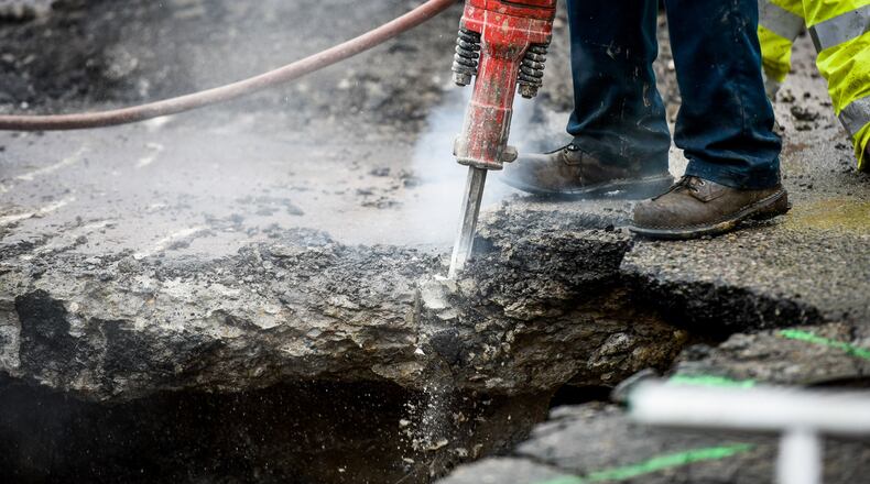 Crews from the city of Middletown work to repair a water main break and sewer pipe collapse that caused a large sinkhole on Crawford Street at the intersection of Logan Avenue Tuesday, Feb. 28, 2017 in Middletown. NICK GRAHAM/STAFF