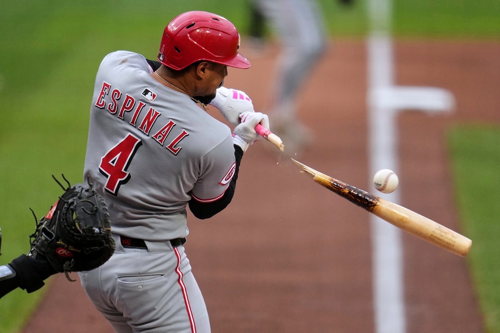 Cincinnati Reds' Santiago Espinal (4) breaks his bat on a infield ground out off Pittsburgh Pirates pitcher Bailey Falter during the first inning of a baseball game in Pittsburgh, Tuesday, May 20, 2025. (AP Photo/Gene J. Puskar)