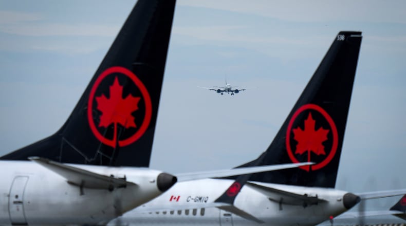 FILE - Air Canada aircraft sit parked at Vancouver International Airport in Richmond, British Columbia, Aug. 18, 2025. (Darryl Dyck/The Canadian Press via AP, file)