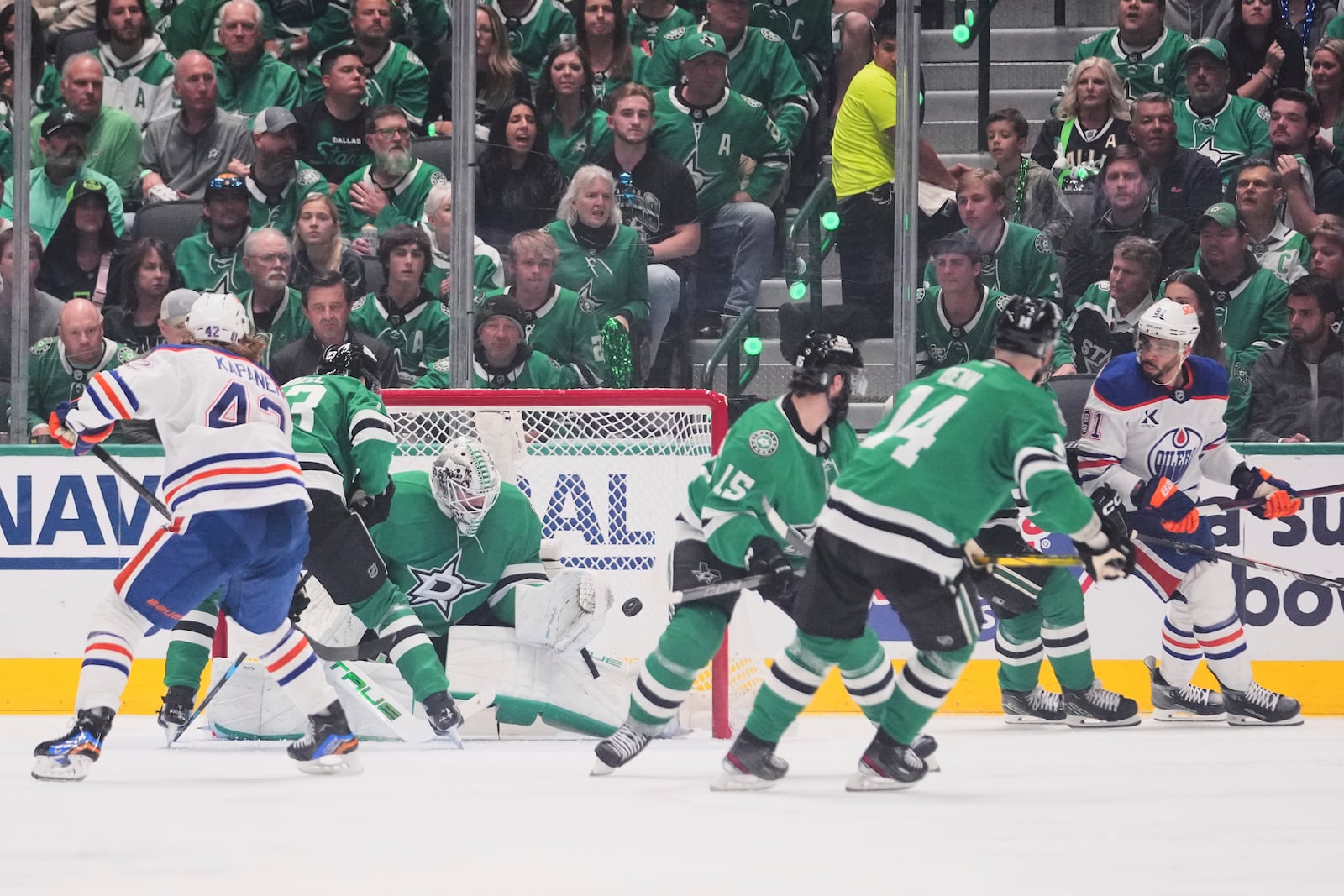 Edmonton Oilers left wing Evander Kane (91) scores against Dallas Stars goaltender Casey DeSmith (1) during the third period of Game 5 of the Western Conference finals in the NHL hockey Stanley Cup playoffs, Thursday, May 29, 2025, in Dallas. (AP Photo/Julio Cortez)