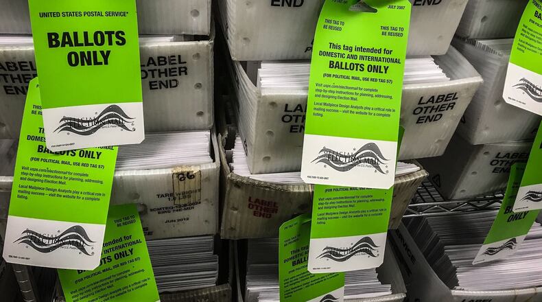 Tuesday, Oct. 6, 2020, marks the first day of early voting in Ohio, and county election boards were sending out thousands of requested absentee ballots. Here, Warren County Board of Elections workers prepare to transport ballots to the post office. In addition to voting absentee, registered voters can cast ballots by in-person early voting. Across Ohio, the hours this week through Friday are from 8 a.m. to 5 p.m. Twice as many Ohioans are expected to vote by mail than in 2016 because of the coronavirus pandemic. JIM NOELKER / STAFF