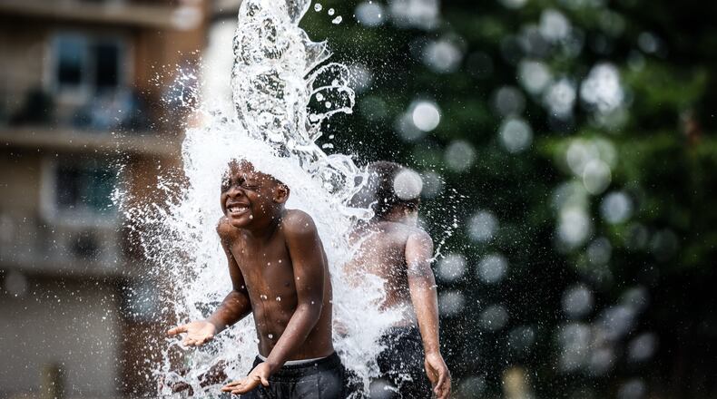 Jaion Pettigrew, 5, from Dayton enjoy the splash park on Edwin C Moses Tuesday afternoon June 29, 2021. Jim Noelker/Staff